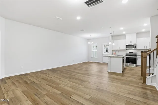 a view of a swimming pool with a lake and houses in the back