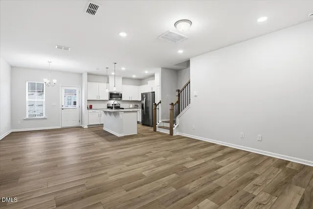a kitchen with stainless steel appliances granite countertop a sink stove and microwave