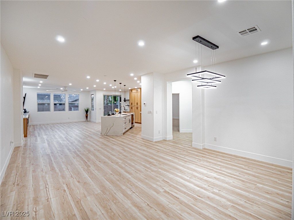 7870 Midnight Ride Street Las Vegas, NV 89131 - Photo 12 of 69 Unfurnished living room with light wood finished floors and recessed lighting