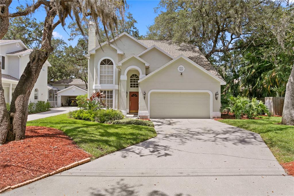 3305 West Hawthorne Road Tampa, FL 33611 - Photo 1 of 1 a front view of a house with a yard and garage