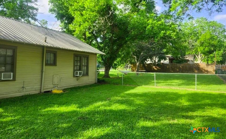 121 Ave G Shiner, TX 77984 - Photo 2 of 7 a view of a backyard with a small cabin
