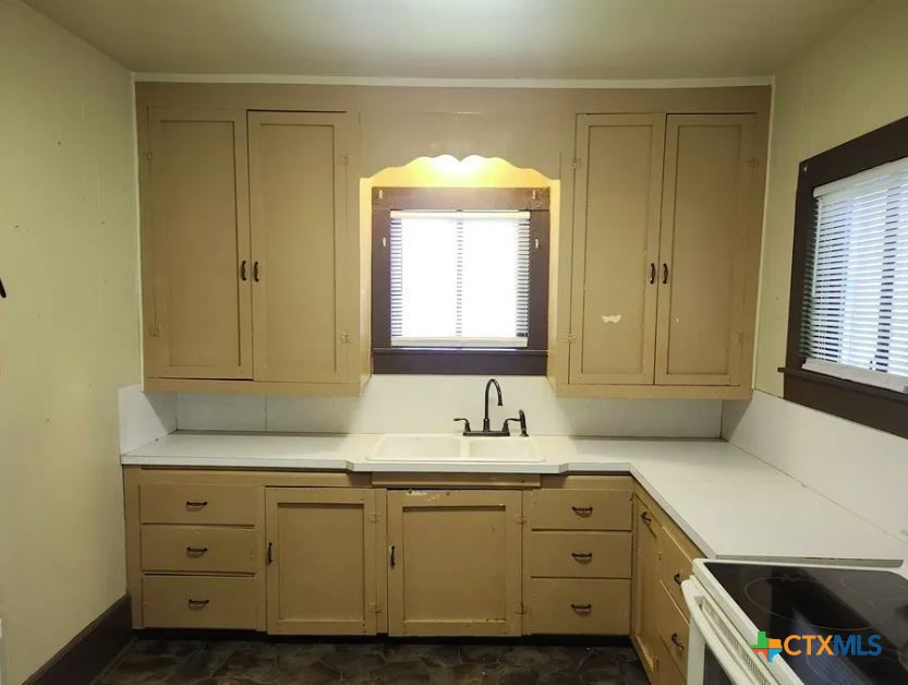 121 Ave G Shiner, TX 77984 - Photo 4 of 7 a bathroom with a sink and a mirror