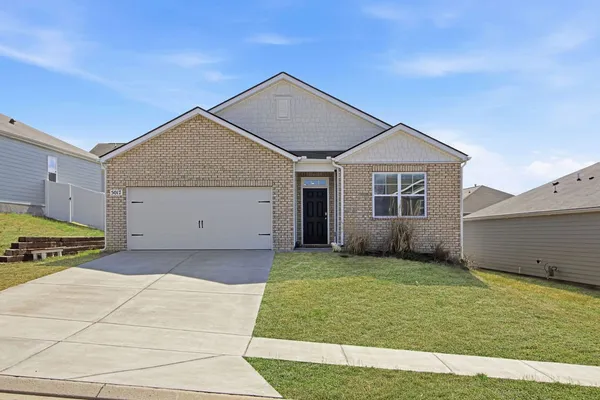 a view of a house with a yard and garage