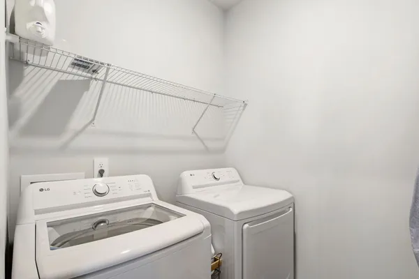 a kitchen with stainless steel appliances granite countertop a stove a refrigerator a dining table and chairs with wooden floor