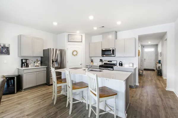 a view of a dining room with furniture and wooden floor