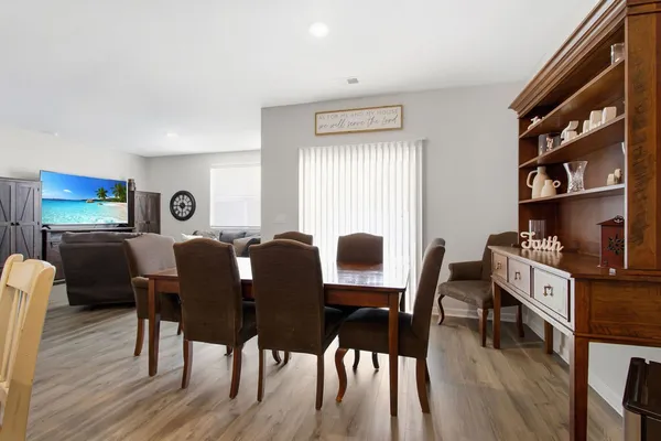 a living room with furniture a large window and a flat screen tv