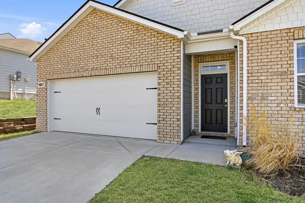 a view of a hallway with wooden floor and closet
