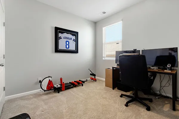a view of a workspace with furniture and closet