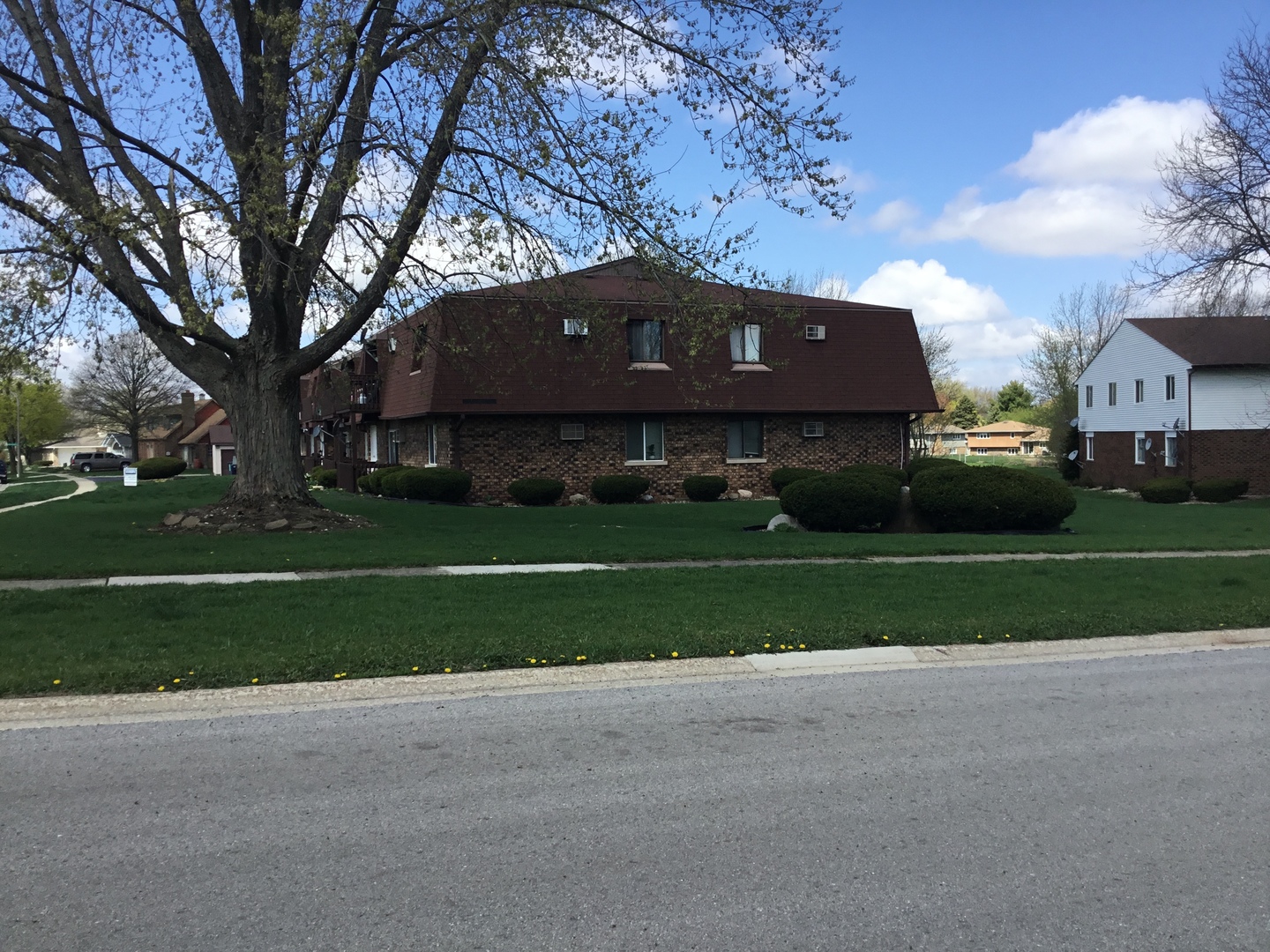 1115 Shagbark Road, Unit 2B New Lenox, IL 60451 - Photo 2 of 19 a front view of a house with a yard