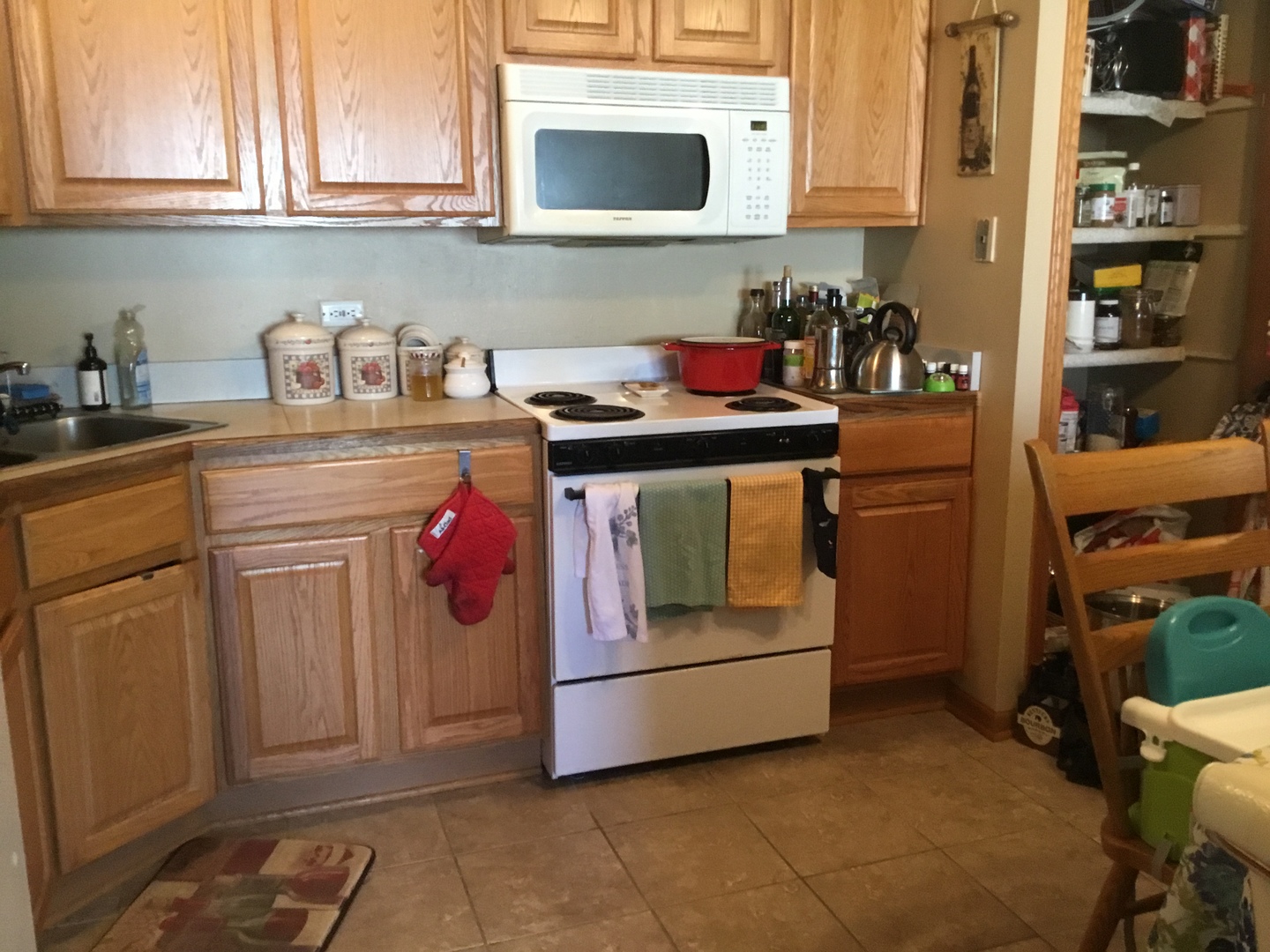 1115 Shagbark Road, Unit 2B New Lenox, IL 60451 - Photo 6 of 19 a kitchen with stainless steel appliances granite countertop a sink and cabinets