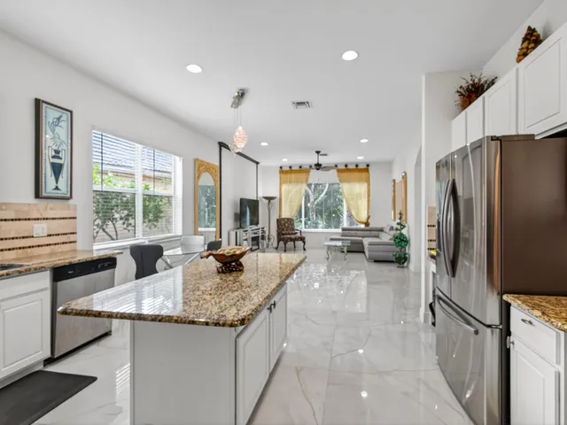 a kitchen with sink refrigerator and window