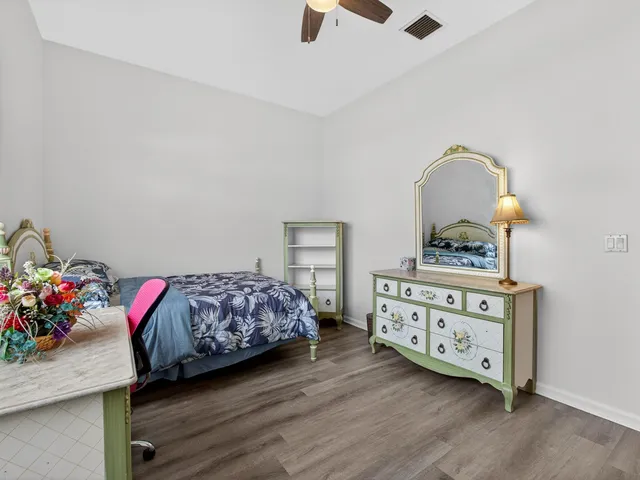 a bedroom with furniture and a dresser