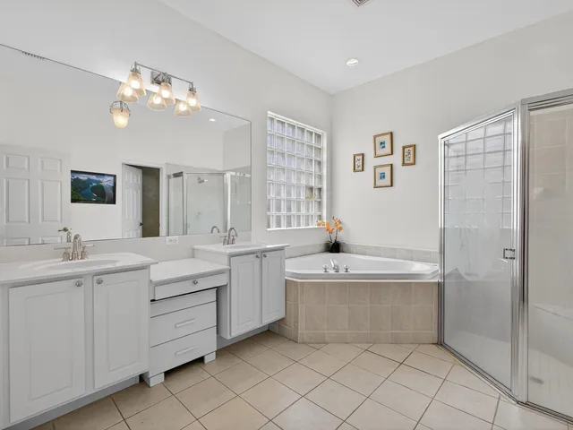 a bathroom with a tub a sink and mirror