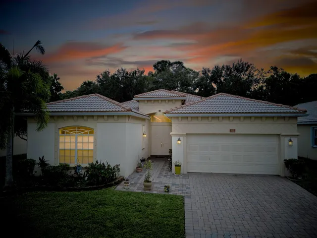 an aerial view of a house with garden space and a yard