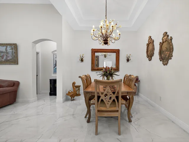 a dining room with furniture and chandelier