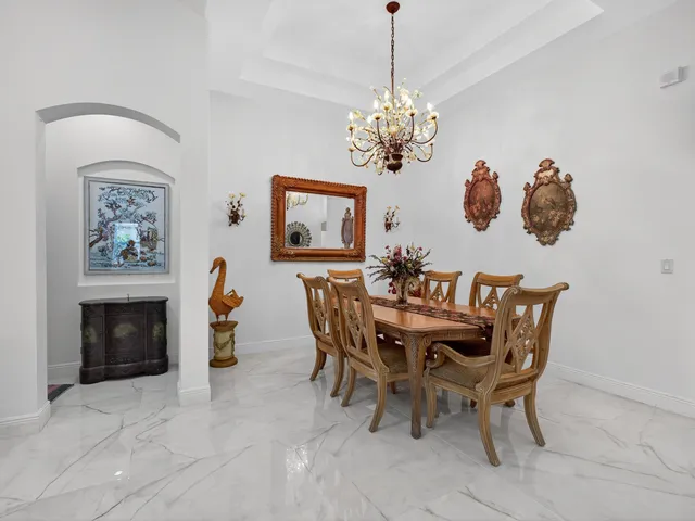 a view of a dining room with furniture and chandelier