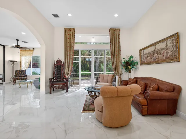a living room with furniture and floor to ceiling window