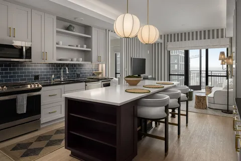 a kitchen with a table chairs stove and cabinets