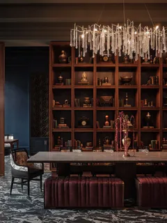 a table with wine bottles and glasses sitting on it