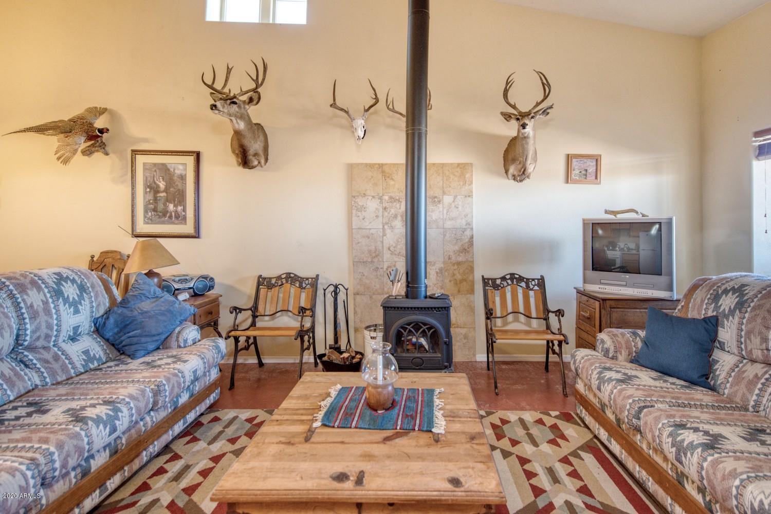 11500 South Duck Tank Road Pearce, AZ 85625 - Photo 11 of 38 a living room with furniture and a flat screen tv