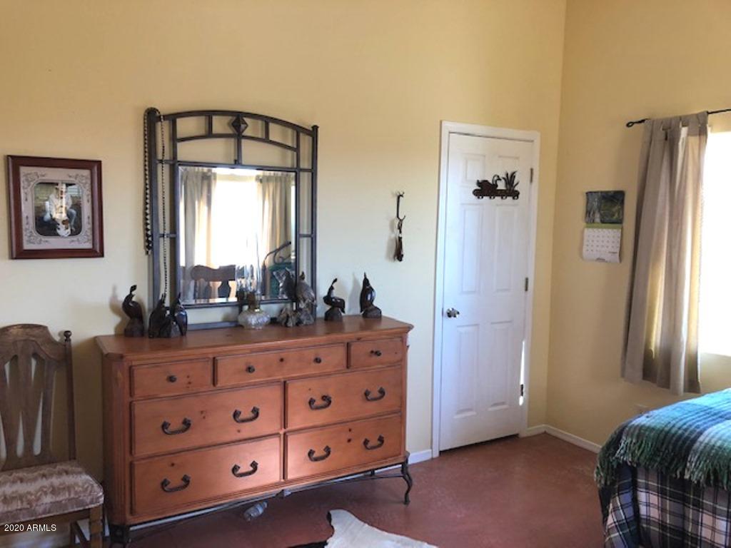 11500 South Duck Tank Road Pearce, AZ 85625 - Photo 16 of 38 a room with a dresser and a mirror