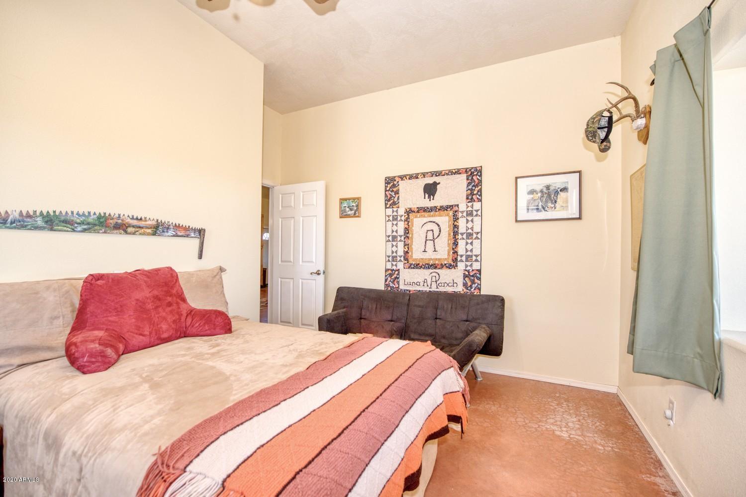 11500 South Duck Tank Road Pearce, AZ 85625 - Photo 20 of 38 a bedroom with a bed and a couch