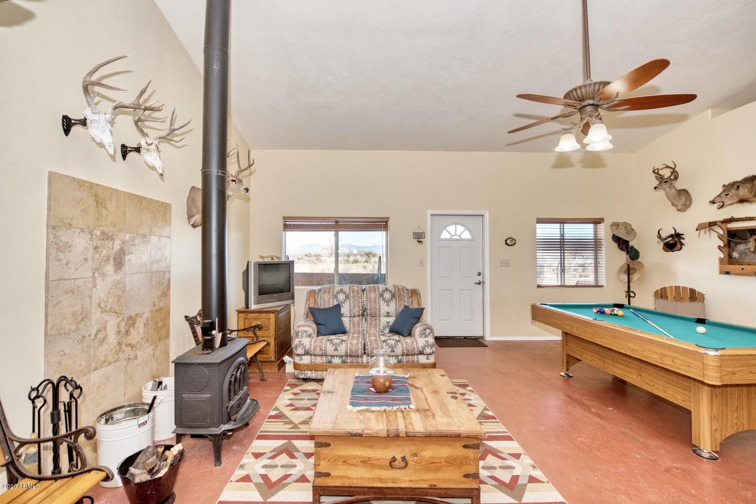 11500 South Duck Tank Road Pearce, AZ 85625 - Photo 7 of 38 a living room with patio furniture and a table
