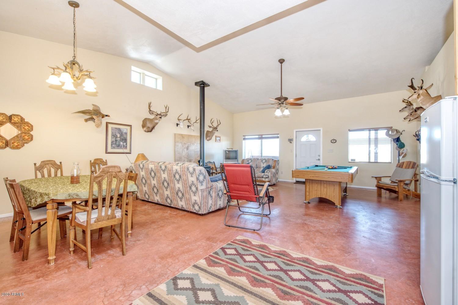 11500 South Duck Tank Road Pearce, AZ 85625 - Photo 8 of 38 a living room with lots of furniture and a chandelier