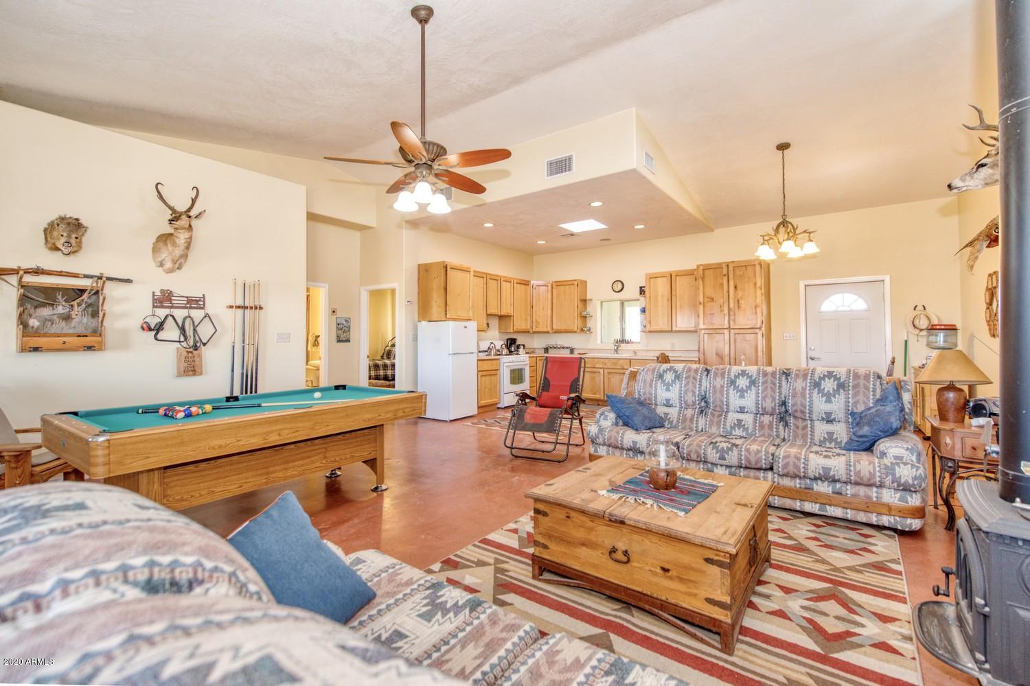 11500 South Duck Tank Road Pearce, AZ 85625 - Photo 10 of 38 a living room with furniture and a chandelier