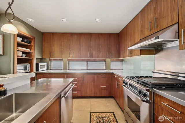 a kitchen with a sink and chairs