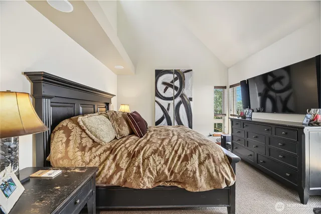 a bathroom with a sink mirror and a shower