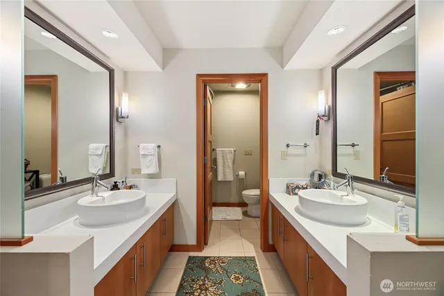 a bathroom with a double vanity sink a mirror and a shower