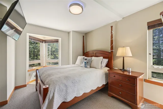 a bed sitting in a bedroom next to a window