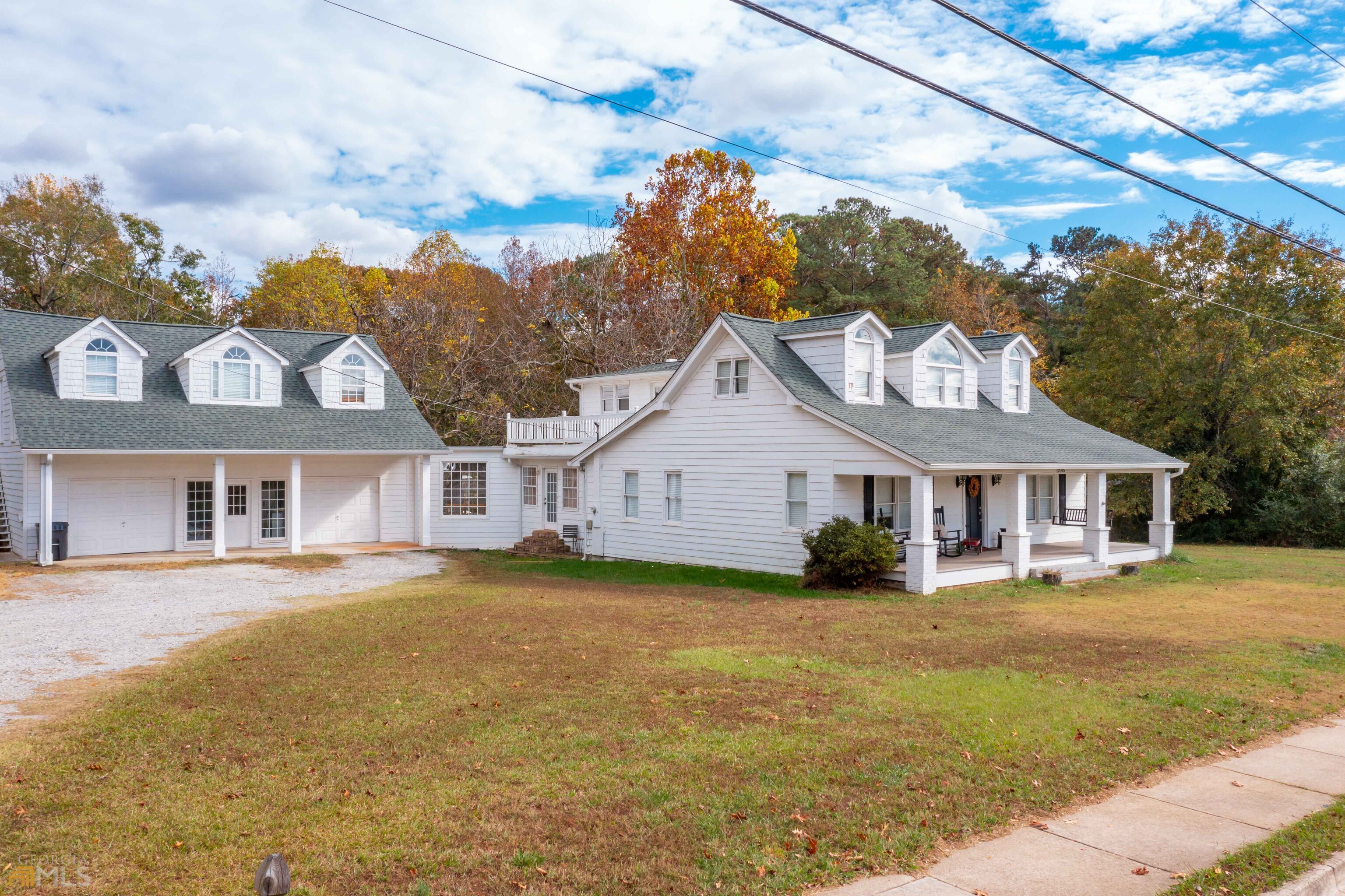12595 Broadwell Road Alpharetta, GA 30004 - Photo 1 of 1 a view of a yard in front of a brick house with large windows