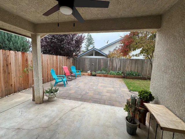 a view of a backyard with plants and outdoor seating