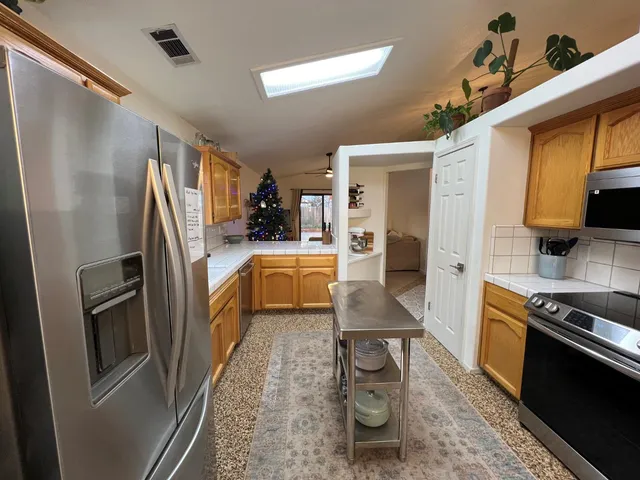 a kitchen with granite countertop a refrigerator and a stove