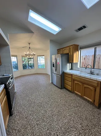 a kitchen with stainless steel appliances granite countertop a sink stove and refrigerator