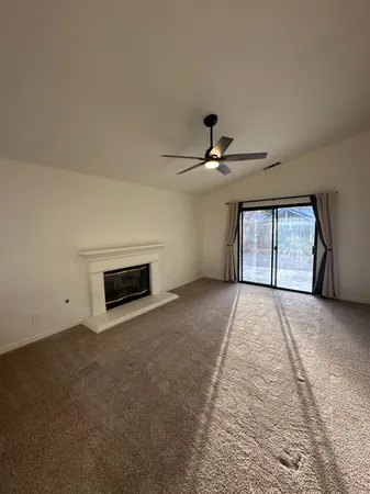 a view of a livingroom with a ceiling fan and window