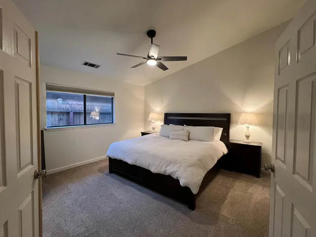 a bedroom with a bed and a chandelier
