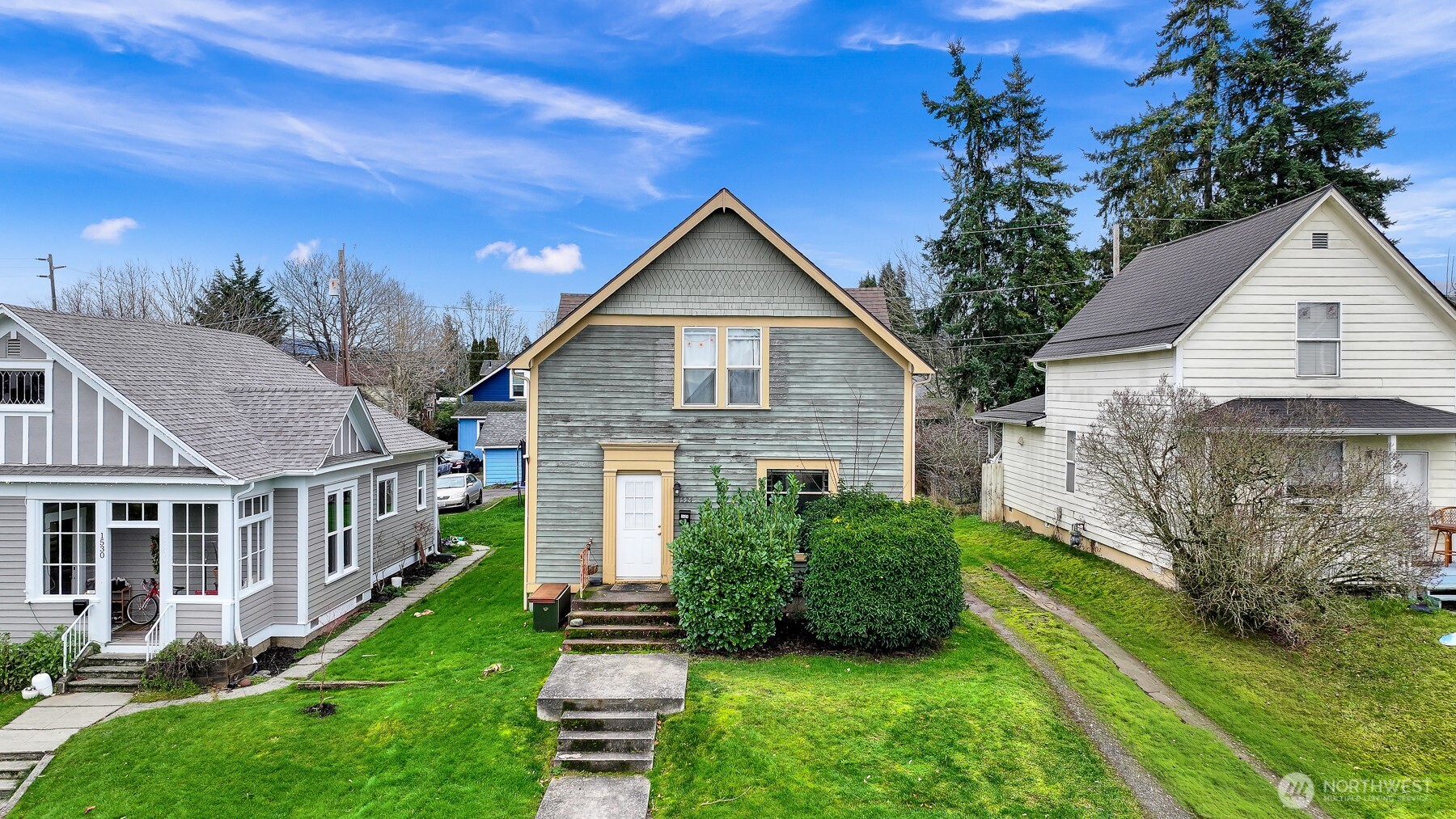 a front view of house with yard and green space