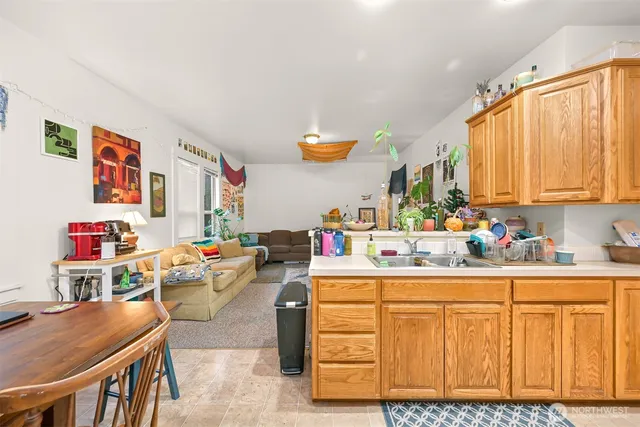 a room with kitchen island a sink stove and cabinets