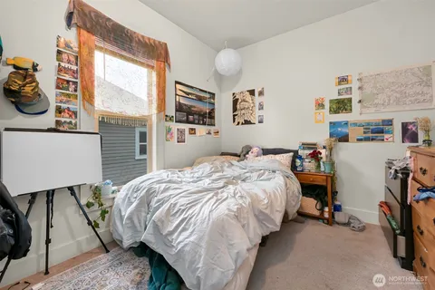 a bed sitting in a bedroom next to a window