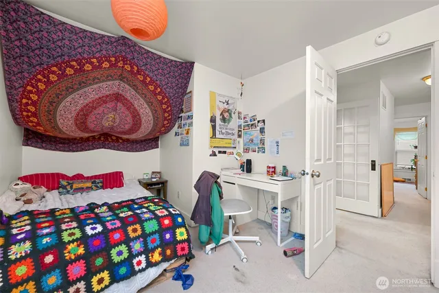 a bedroom with a bed and a chandelier