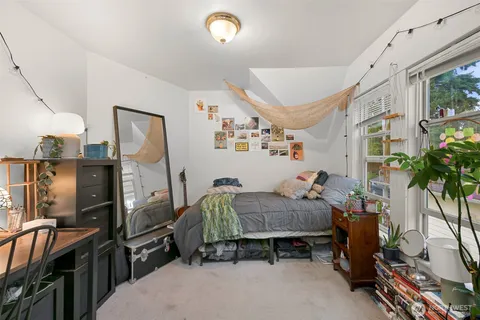 a bedroom with furniture and a flat screen tv