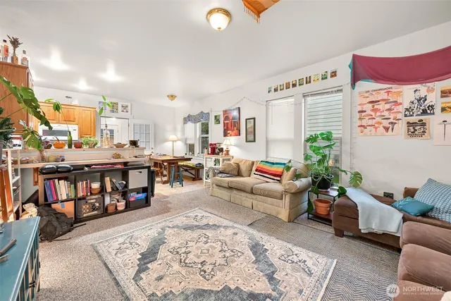 a living room with furniture and a book shelf