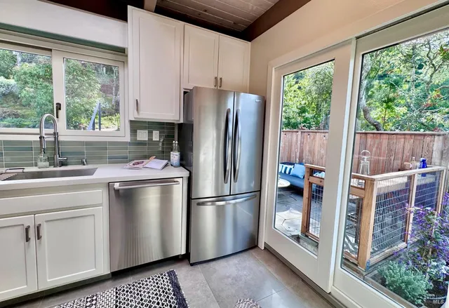 a kitchen with stainless steel appliances a refrigerator sink and cabinets