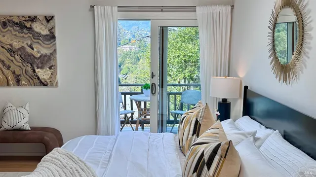 a view of a bedroom with furniture and a window