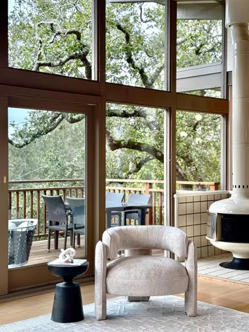a living room with large windows and a couch