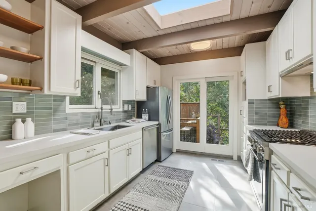 a kitchen with a sink stove and cabinets