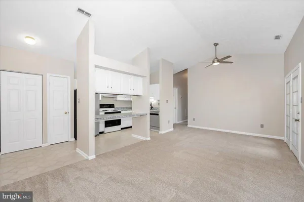 a view of a kitchen with a sink dishwasher and wooden floor